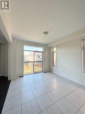 East Gwillimbury (Holland Landing) apartment for rent - A spacious room with a tiled floor and a balcony with a railing.
