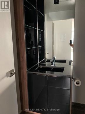 Toronto (Bay Street Corridor) condo for rent - A modern bathroom with a sink and mirror.