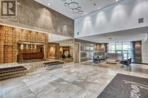 Markham (Unionville) condo for rent - A spacious lobby with a marble floor and a glass wall.