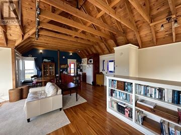 St. John's apartment for rent - A living room with a white couch and a bookshelf filled with books.
