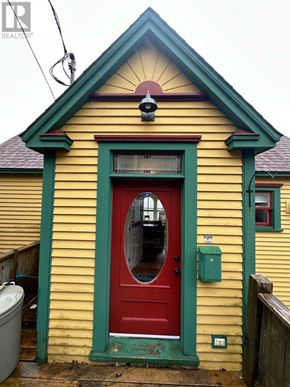 St. John's apartment for rent - A yellow house with a red door and a green trim.