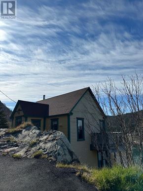 St. John's apartment for rent - A house with a brown roof is situated on a rocky outcrop.