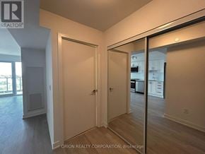Pickering (Bay Ridges) condo for rent - A room with a white door and a mirror on the wall.