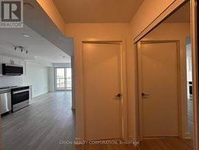 Pickering (Bay Ridges) condo for rent - A realtor photo of a room with a kitchen and a door.