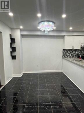 Ajax (Northwest Ajax) townhouse for rent - A kitchen with black tiles on the floor and white walls.