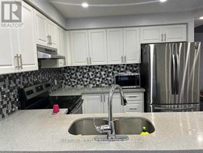 Ajax (Northwest Ajax) townhouse for rent - A kitchen with a sink and a refrigerator.