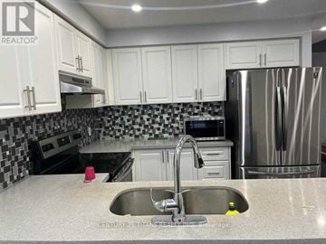 Ajax (Northwest Ajax) townhouse for rent - A kitchen with a sink and a refrigerator.