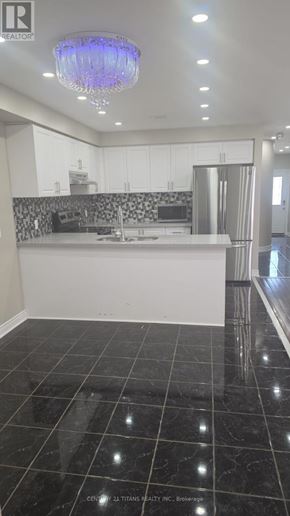 Ajax (Northwest Ajax) townhouse for rent - A room with wooden floors and a window with brown curtains.