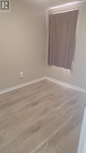 Ajax (Northwest Ajax) townhouse for rent - A room with light wood flooring and a curtain hanging on the window.