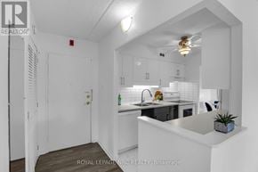 St. Catharines (Fairview) condo for rent - A white kitchen with a sink and a plant on the counter.