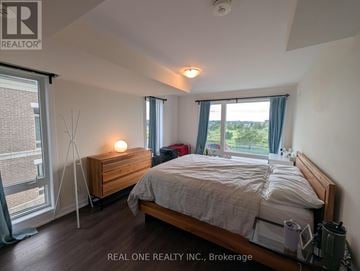 Markham (Cornell) townhouse for rent - A bedroom with a bed, nightstand, and window.