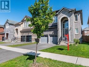 Halton Hills (Georgetown) apartment for rent - A large house with a stone facade and a red sculpture in front.