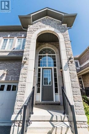 Halton Hills (Georgetown) apartment for rent - A house with a grey front door and a stone pillar.