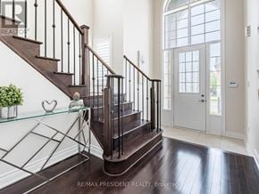 Halton Hills (Georgetown) apartment for rent - A staircase with a glass railing and a wooden handrail.