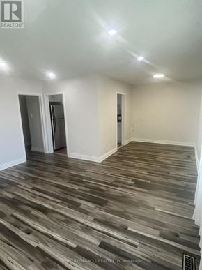 Brampton (Brampton South) apartment for rent - A room with wooden flooring and white walls.