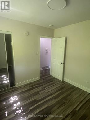 Brampton (Brampton South) apartment for rent - A room with a wooden floor and a white door.