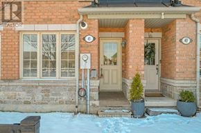 Brampton (Sandringham-Wellington) townhouse for rent - A red brick house with a white door and a small tree in a pot.