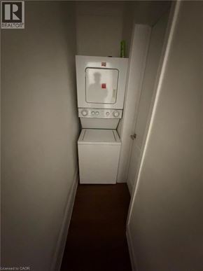 Brantford apartment for rent - A white refrigerator in a narrow hallway.