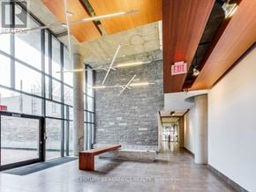 Toronto (Waterfront Communities) condo for rent - A large room with a bench and a stone wall.