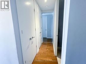 Toronto (Waterfront Communities) condo for rent - A hallway with white doors and a wooden floor.