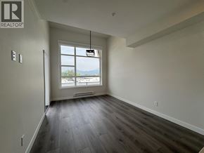 Maple Ridge apartment for rent - A room with a window overlooking a cityscape.