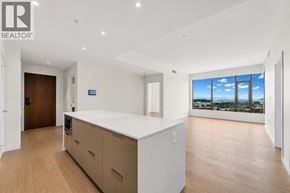 North Vancouver apartment for rent - A spacious kitchen with wooden floors and a large window overlooking the city.
