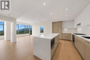 North Vancouver apartment for rent - A modern kitchen with a large island and wooden floors.