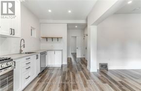 Hamilton (Gibson) apartment for rent - A modern kitchen with white cabinets and a wooden floor.