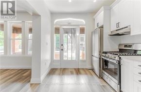 Hamilton (Gibson) apartment for rent - A modern kitchen with white cabinets and a stainless steel oven.