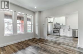 Hamilton (Gibson) apartment for rent - A well-lit, spacious kitchen and living room with wood flooring and white walls.