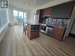 Toronto (University) condo for rent - A modern kitchen with wooden floors and stainless steel appliances.