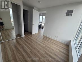 Toronto (University) condo for rent - A room with wooden floors and white walls.