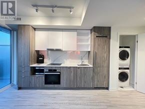 Toronto (Waterfront Communities) condo for rent - A modern kitchen with wooden cabinets and appliances.
