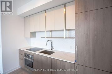 Toronto (Willowdale East) condo for rent - A modern kitchen with wooden cabinets and a stainless steel sink.