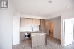 Toronto (Willowdale East) condo for rent - A modern kitchen with a stainless steel oven and wooden cabinets.