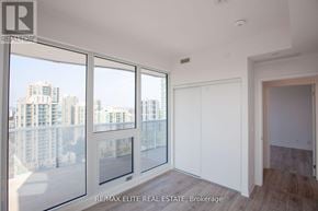 Toronto (Willowdale East) condo for rent - A room with a view of a cityscape through large windows.