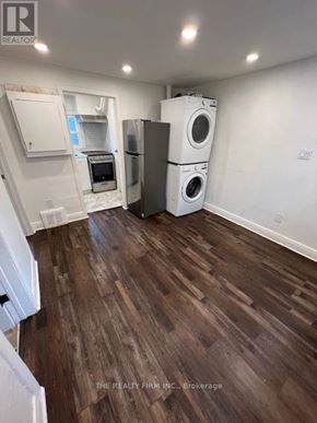 London South (South F) fourplex for rent - A laundry room with a washer and dryer stacked on top of each other.