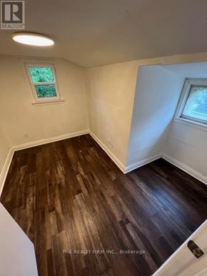 London South (South F) fourplex for rent - A room with wooden flooring and a window.