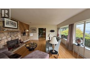 West Vancouver apartment for rent - A living room with a stone fireplace and a grey couch.