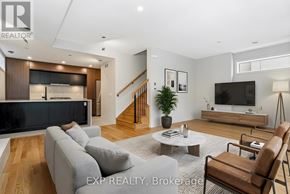 Ottawa apartment for rent - A living room with a grey sofa, a wooden coffee table, and a television.