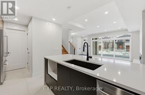 Ottawa apartment for rent - A modern kitchen with a large island and a sink.
