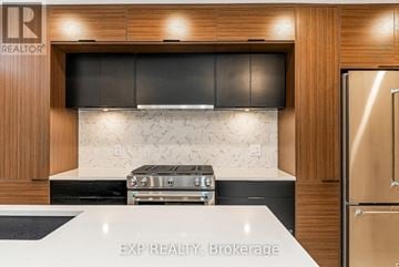 Ottawa apartment for rent - A modern kitchen with a stove top oven and a refrigerator.