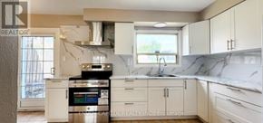 Toronto (Humbermede) apartment for rent - A kitchen with white cabinets and a marble countertop.