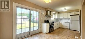 Toronto (Humbermede) apartment for rent - A kitchen with white appliances and a large window.