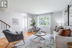 Mississauga (Applewood) townhouse for rent - A living room with a grey chair and a white couch.