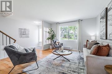 Mississauga (Applewood) townhouse for rent - A living room with a grey chair and a white couch.