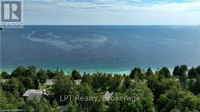 Northern Bruce Peninsula apartment for rent - A real estate brokerage logo is superimposed on a scenic coastal image.