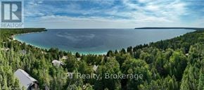 Northern Bruce Peninsula apartment for rent - A real estate brokerage logo is displayed on a scenic image of a coastal area.