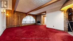 Toronto (Scarborough Village) apartment for rent - A room with a red carpet and wooden walls.
