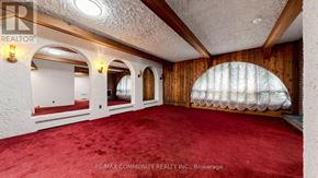 Toronto (Scarborough Village) apartment for rent - A room with a red carpet and wooden walls.